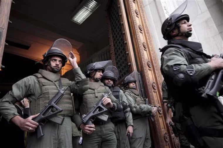 Army special forces stand at the entrance to the Egyptian Museum before a tour for the press in Cairo, Egypt, Wednesday Feb. 16, 2011. Dr. Zahi Hawass, Director for the Supreme Council of Antiquities said that three of the 18 items reporting missing from Cairo's Egyptian Museum had been found. According to Hawass thieves entered the museum during the mass street protests that led to the ouster of former Egyptian President Hosni Mubarak. (AP Photo/Tara Todras-Whitehill)